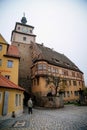 Medieval gothic clock White Tower or Weisser Turm and half-timbered house on Georgengasse street, autumn day, Old Town