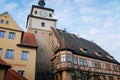 Medieval gothic clock White Tower or Weisser Turm and half-timbered house on Georgengasse street, sunny day, Old Town