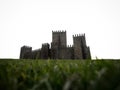 Medieval gothic stone rock castle fortification Castelo de Guimaraes with green grass Norte Region Cradle of Portugal Royalty Free Stock Photo