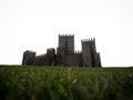 Medieval gothic stone rock castle fortification Castelo de Guimaraes with green grass Norte Region Cradle of Portugal Royalty Free Stock Photo