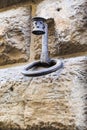 Medieval hitching post with torch holder on the wall of an old house in Florence Royalty Free Stock Photo