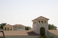 Medieval house in the Romanesque style, surrounded by palm trees