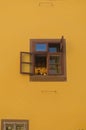 Old brown wooden window opened, yellow painted wall of historical old building, house Royalty Free Stock Photo