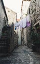 Medieval houses in the narrow streets of Dubrovnik with hanging clothes and stone stairs