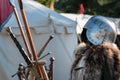 Medieval Iron Helmet, Metallic Armor and Fur Coat, Swords And White Tent in background