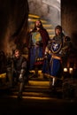 Medieval king with his knights in ancient castle interior Royalty Free Stock Photo