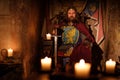 Medieval king on throne in ancient castle interior.