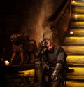 Medieval knight in ancient castle interior. Royalty Free Stock Photo