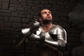 Medieval knight kneeling with sword Royalty Free Stock Photo