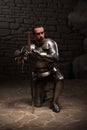 Medieval knight kneeling with sword Royalty Free Stock Photo