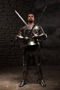 Medieval Knight posing with two swords on in a Royalty Free Stock Photo