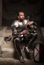 Medieval knight sitting on the steps of ancient Royalty Free Stock Photo