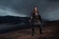 Medieval knight with sword in armor as style Game of Thrones in Royalty Free Stock Photo