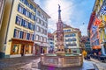 The medieval limestone fountain on Weinmarkt square in surrounding of outstanding old houses, on March 30 in Lucerne, Switzerland