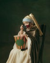 Medieval little girl as a lady with a pearl earring on dark studio background. Concept of comparison of eras, childhood