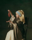 Medieval little girl as a lady with a pearl earring on dark studio background. Concept of comparison of eras, childhood