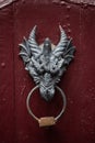 Dragon head door knocker on red wooden door