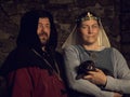 Medieval lovers. Fairy couple with a weasel in costumes Royalty Free Stock Photo