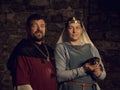 Medieval lovers. Fairy couple with a weasel in costumes Royalty Free Stock Photo