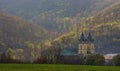 Medieval monastery in Hronsky Benadik (Slovakia), ancient Gothic building, spring nature, orchard.