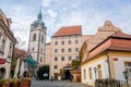 Medieval narrow old city street with numerous cafes, castle and high clock tower of the Church of Saints Peter and Paul in Melnik Royalty Free Stock Photo