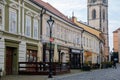 Medieval narrow old city street with numerous cafes, castle and high clock tower of the Church of Saints Peter and Paul in Melnik Royalty Free Stock Photo