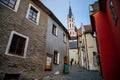 Medieval narrow street with colorful renaissance historical buildings, tower of the St. Vitus Church in the center of Cesky