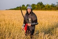 A medieval nomad warrior in oriental armor on the background of a wheat field. Standing in a fencing rack Royalty Free Stock Photo