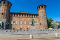 Medieval old Acaja Castle with brick towers and Monumento Emanuele Filiberto Duca d`Aosta on Castle Square Piazza Castello in his