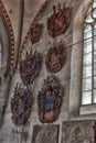 Medieval old family coat of arms hanging on the wall Royalty Free Stock Photo