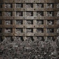 Medieval old rusty metal lattice on stone wall Royalty Free Stock Photo