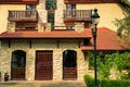 Medieval palace hotel outdoor exterior facade side with entrance door and street lantern foreground