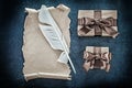 Medieval paper scroll plume gift boxes on black background Royalty Free Stock Photo