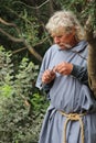 Medieval Peasant Whittling a Piece of Wood