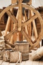 A medieval port with a wooden winch for lifting cargo onto ships. Reco