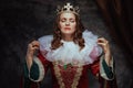 medieval queen in red dress with white collar and crown Royalty Free Stock Photo