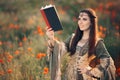 Medieval Reading a Book in a Magical Field of Poppies Royalty Free Stock Photo