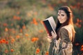 Medieval Reading a Book in a Magical Field of Poppies Royalty Free Stock Photo