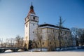 Medieval renaissance water castle with half-timbered tower with snow in winter sunny day, Historic Romantic chateau Blatna near Royalty Free Stock Photo