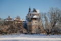Medieval renaissance water castle with half-timbered tower with snow in winter sunny day, Historic Romantic chateau Blatna near Royalty Free Stock Photo