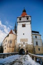 Medieval renaissance water castle with half-timbered tower with snow in winter sunny day, Historic Romantic chateau Blatna near