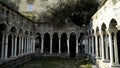 Medieval ruins with colonnade in old city. Action. Landmark in city center with abandoned ruins of monastery with Royalty Free Stock Photo