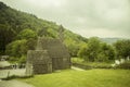 Medieval St. Kevin`s Church or `Kitchen` , Glendalough in County Wicklow, Ireland. Stone-roofed building in green valley