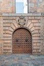 Medieval steel arched gate in a stone wall of a building in Barcelona