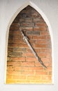 Medieval steel sword against the brick wall background. Ancient shining sword used as decoration