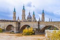 Medieval stone bridge on the backdrop of the towers of Church in Zaragoza Royalty Free Stock Photo