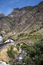 Medieval stone bridge over the river in Espot village in Pyrenees mountains Royalty Free Stock Photo