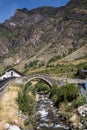 Medieval stone bridge over the river in Espot village in Pyrenees mountains Royalty Free Stock Photo