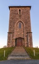 The medieval stone church at Avaldsnes, on the Island of Karmoy, Norway, vertical image of the front entrance and stairs Royalty Free Stock Photo