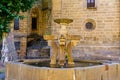 Medieval stone fountain next to the Romanesque church of the old village of Barco de Avila, Spain.